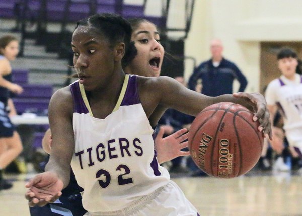 Lemoore's Amaya Sanchez drives to basket in third quarter as Tigers beat Redwood in their West Yosemite League opener.